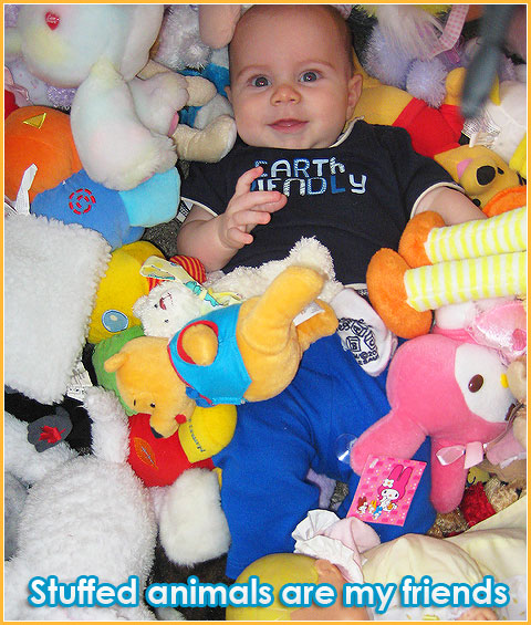 Matteo surrounded by stuffed animals